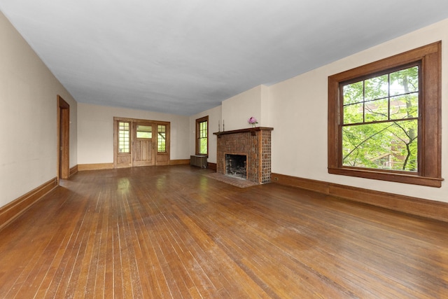 1706 S University Ave, Ann Arbor, MI 48104 - unfurnished living room with wood-type flooring, a fireplace, and baseboards
