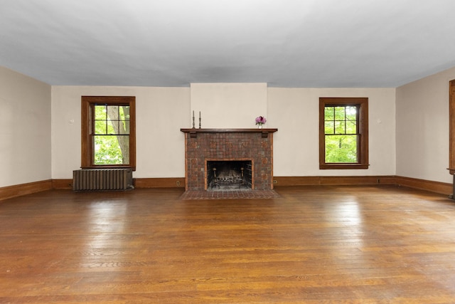 1706 S University Ave, Ann Arbor, MI 48104 - unfurnished living room featuring radiator, hardwood / wood-style flooring, plenty of natural light, and a fireplace