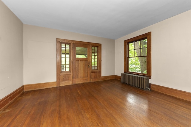 1706 S University Ave, Ann Arbor, MI 48104 - foyer entrance featuring radiator heating unit, wood finished floors, and baseboards