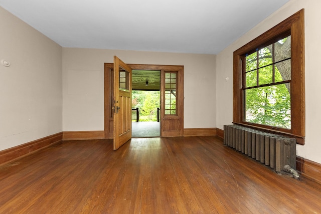 1706 S University Ave, Ann Arbor, MI 48104 - unfurnished room featuring radiator heating unit, wood finished floors, baseboards, and plenty of natural light