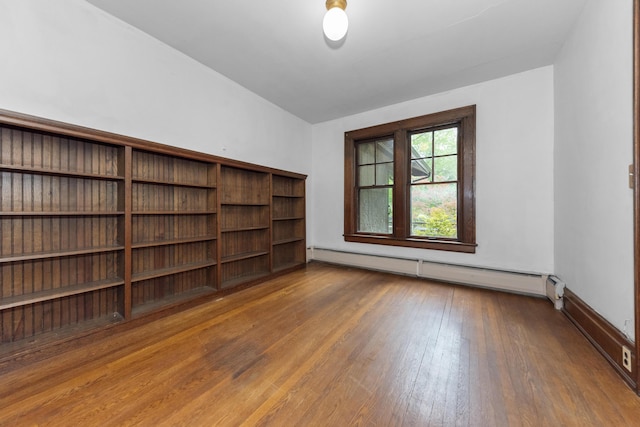 1706 S University Ave, Ann Arbor, MI 48104 - spare room featuring a baseboard radiator, wood-type flooring, and lofted ceiling
