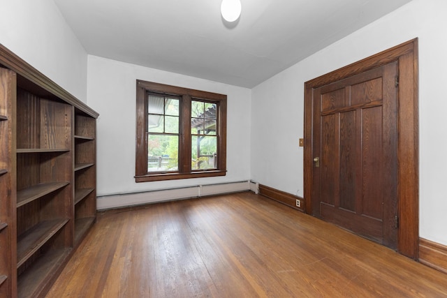 1706 S University Ave, Ann Arbor, MI 48104 - unfurnished bedroom featuring baseboard heating, wood finished floors, and baseboards