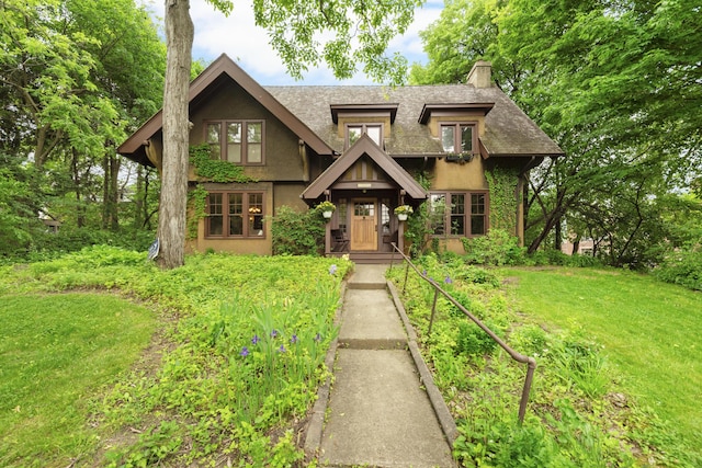 1706 S University Ave, Ann Arbor, MI 48104 - view of front of home with a chimney, stucco siding, a front yard, and roof with shingles