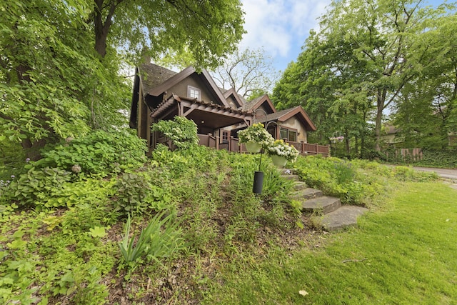 1706 S University Ave, Ann Arbor, MI 48104 - view of side of home featuring a wooden deck and a yard