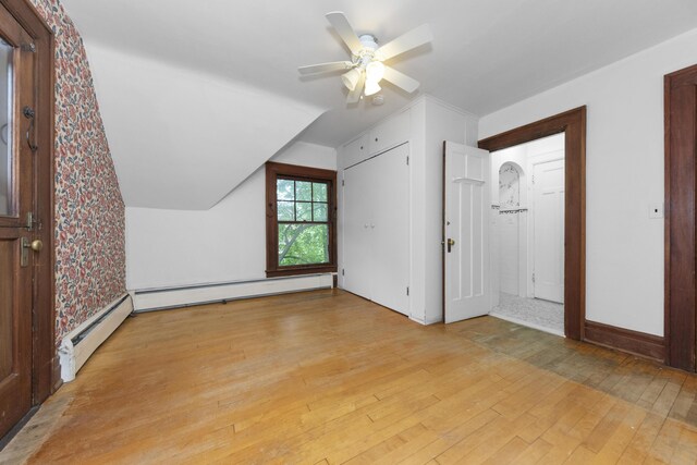 1706 S University Ave, Ann Arbor, MI 48104 - bonus room featuring light wood-style floors, vaulted ceiling, ceiling fan, a baseboard heating unit, and a baseboard radiator
