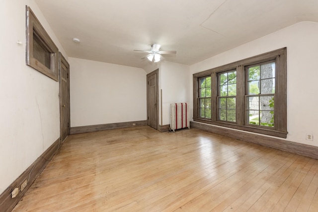 1706 S University Ave, Ann Arbor, MI 48104 - spare room with radiator, a ceiling fan, light wood-type flooring, and baseboards