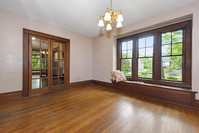 1706 S University Ave, Ann Arbor, MI 48104 - spare room with a chandelier, wood-type flooring, and baseboards