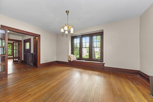 1706 S University Ave, Ann Arbor, MI 48104 - spare room with a chandelier, hardwood / wood-style flooring, and baseboards