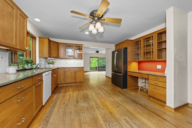 1706 S University Ave, Ann Arbor, MI 48104 - kitchen with freestanding refrigerator, dishwasher, brown cabinets, a ceiling fan, and a sink