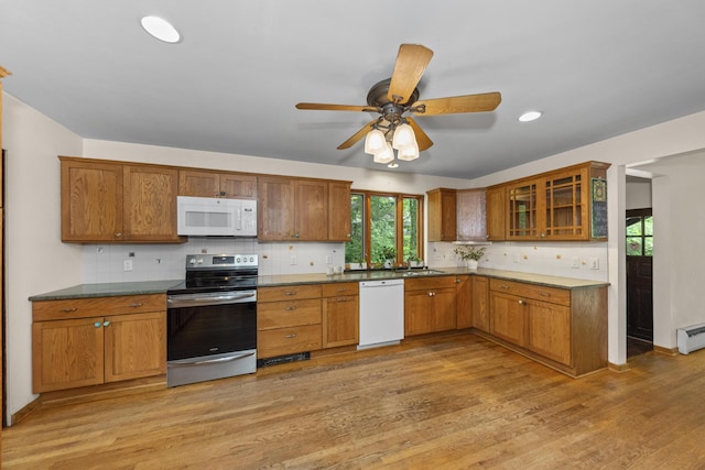 1706 S University Ave, Ann Arbor, MI 48104 - kitchen with white appliances, a sink, backsplash, light wood-style floors, and brown cabinetry