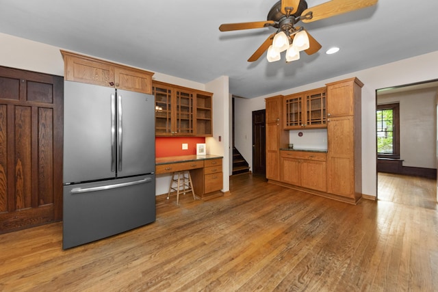 1706 S University Ave, Ann Arbor, MI 48104 - kitchen featuring freestanding refrigerator, glass insert cabinets, light wood finished floors, brown cabinets, and open shelves