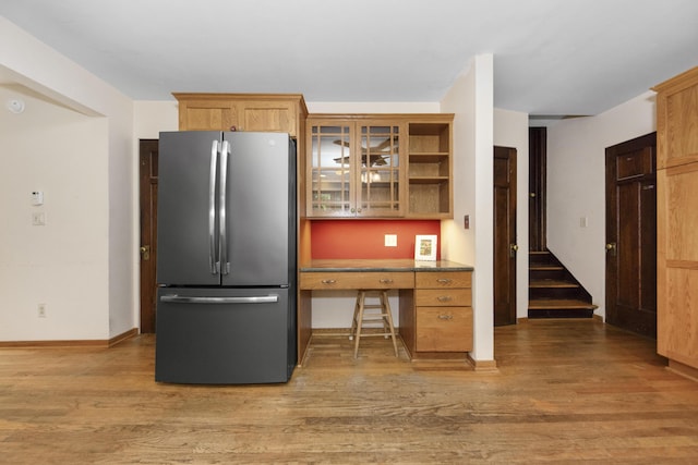1706 S University Ave, Ann Arbor, MI 48104 - kitchen featuring freestanding refrigerator, light wood-style flooring, glass insert cabinets, and baseboards