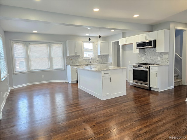 13965 Norborne, Redford, MI 48239 - kitchen featuring appliances with stainless steel finishes, a sink, decorative backsplash, white cabinetry, and dark wood-style floors