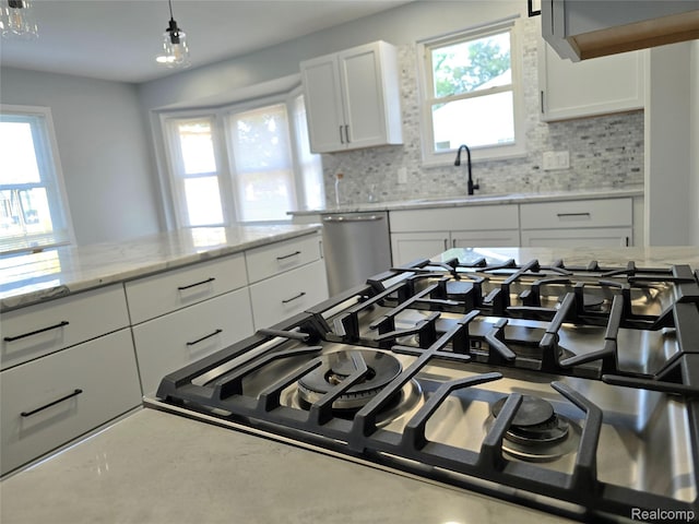 13965 Norborne, Redford, MI 48239 - kitchen with a sink, stainless steel dishwasher, gas stovetop, decorative backsplash, and white cabinetry
