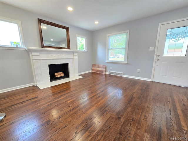 13965 Norborne, Redford, MI 48239 - unfurnished living room with dark wood-style flooring, a brick fireplace, recessed lighting, and baseboards
