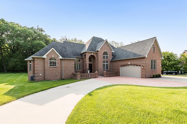4297 Upper Glade Ct, Ann Arbor, MI 48103 - view of front of home with brick siding, a shingled roof, driveway, a front yard, and an attached garage