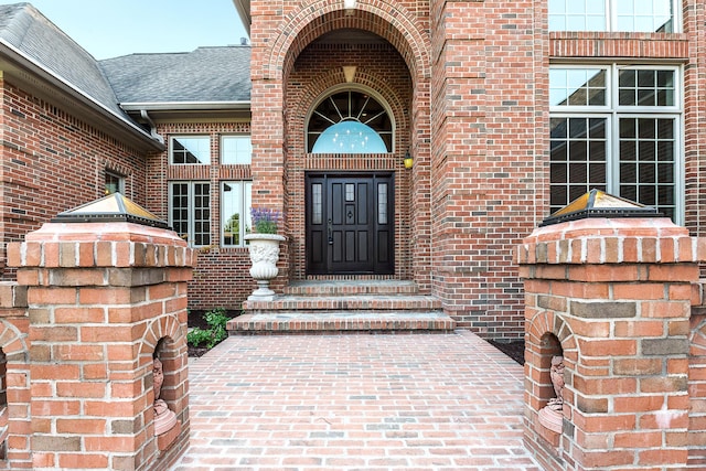 4297 Upper Glade Ct, Ann Arbor, MI 48103 - view of exterior entry featuring brick siding and roof with shingles
