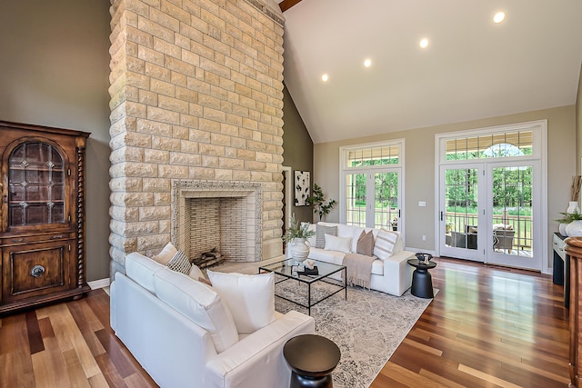 4297 Upper Glade Ct, Ann Arbor, MI 48103 - living room with high vaulted ceiling, wood finished floors, baseboards, a fireplace, and recessed lighting