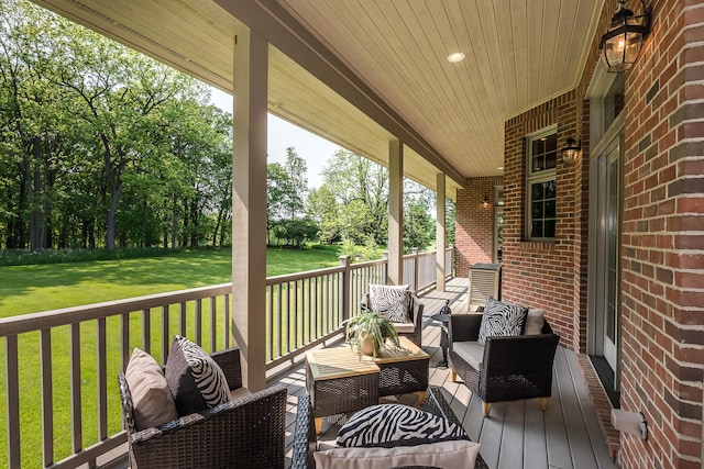 4297 Upper Glade Ct, Ann Arbor, MI 48103 - wooden terrace with outdoor lounge area, a yard, and view of wooded area