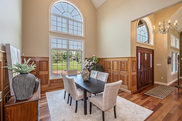 4297 Upper Glade Ct, Ann Arbor, MI 48103 - dining room with high vaulted ceiling, a chandelier, wood finished floors, and a wainscoted wall