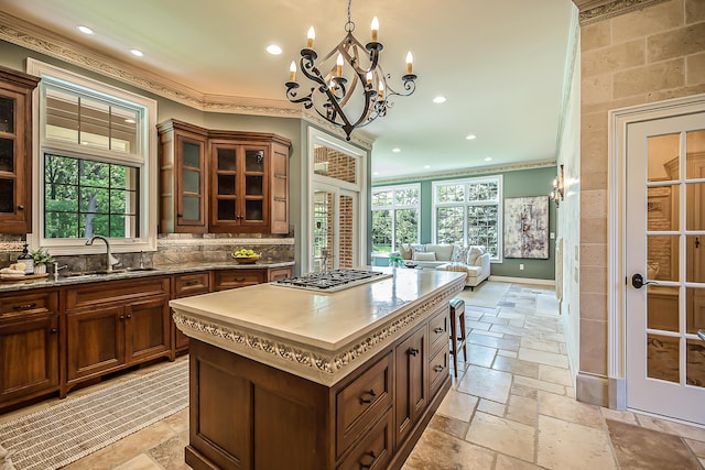 4297 Upper Glade Ct, Ann Arbor, MI 48103 - kitchen with a sink, stone tile floors, plenty of natural light, stainless steel gas stovetop, and ornamental molding