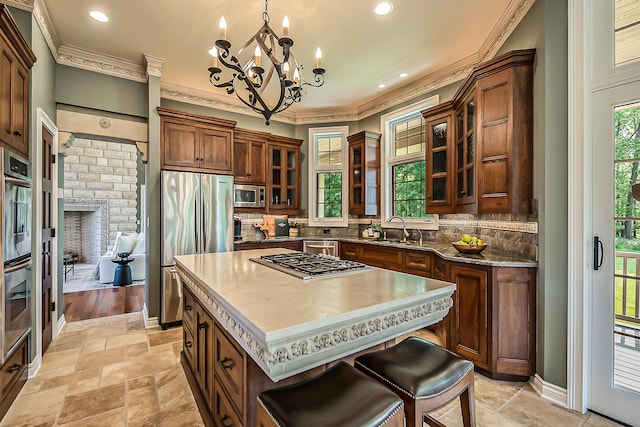 4297 Upper Glade Ct, Ann Arbor, MI 48103 - kitchen with stainless steel appliances, a sink, a chandelier, tasteful backsplash, and crown molding