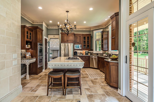 4297 Upper Glade Ct, Ann Arbor, MI 48103 - kitchen with stainless steel appliances, crown molding, a chandelier, a center island, and backsplash