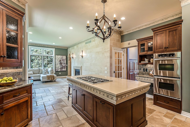 4297 Upper Glade Ct, Ann Arbor, MI 48103 - kitchen featuring stainless steel appliances, ornamental molding, a chandelier, recessed lighting, and stone tile floors