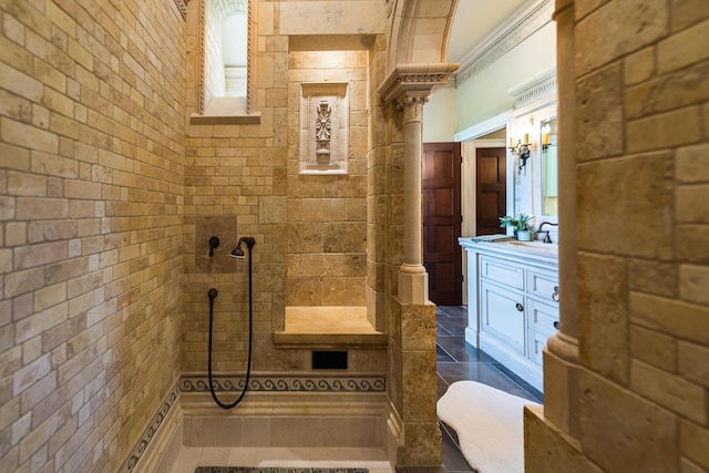 4297 Upper Glade Ct, Ann Arbor, MI 48103 - bathroom featuring vanity, tiled shower, and ornate columns