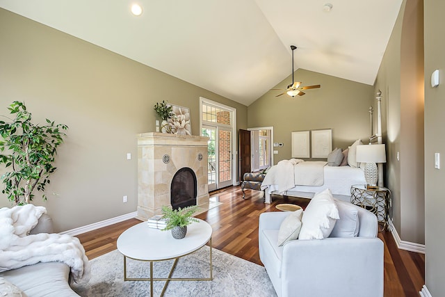 4297 Upper Glade Ct, Ann Arbor, MI 48103 - living area with a tiled fireplace, a ceiling fan, wood finished floors, baseboards, and high vaulted ceiling