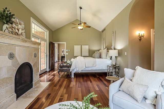 4297 Upper Glade Ct, Ann Arbor, MI 48103 - bedroom featuring wood finished floors, a tiled fireplace, high vaulted ceiling, access to exterior, and ceiling fan