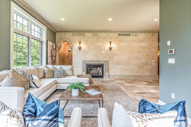 4297 Upper Glade Ct, Ann Arbor, MI 48103 - living area featuring stone tile floors, baseboards, ornamental molding, recessed lighting, and a tile fireplace