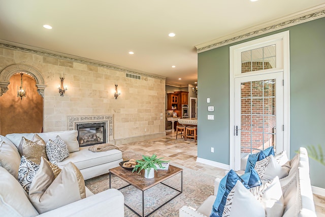 4297 Upper Glade Ct, Ann Arbor, MI 48103 - living area featuring baseboards, crown molding, recessed lighting, a fireplace, and light stone finish floors