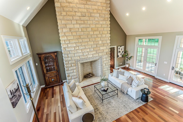4297 Upper Glade Ct, Ann Arbor, MI 48103 - living room featuring high vaulted ceiling, wood finished floors, baseboards, recessed lighting, and a fireplace
