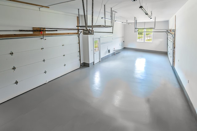 4297 Upper Glade Ct, Ann Arbor, MI 48103 - garage with baseboards and a garage door opener