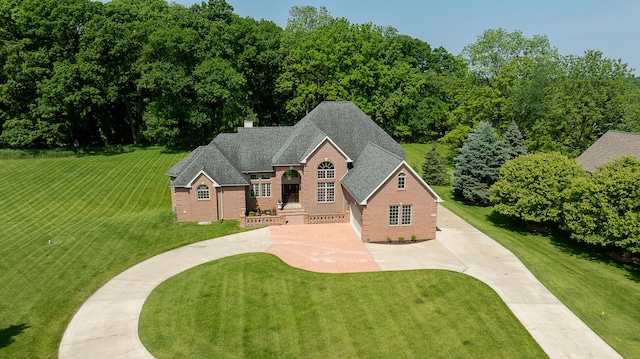 4297 Upper Glade Ct, Ann Arbor, MI 48103 - view of front of property with brick siding, a shingled roof, driveway, and a front lawn