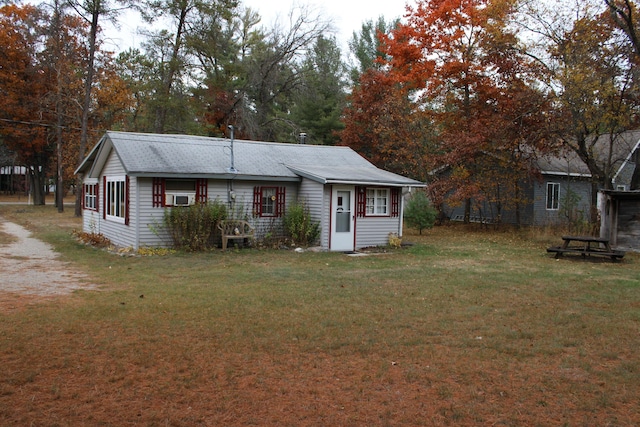 94 E Cherry Creek Rd, Mio, MI 48647 - rear view of house featuring a lawn