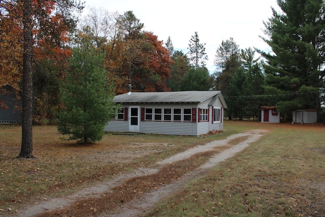 94 E Cherry Creek Rd, Mio, MI 48647 - single story home with dirt driveway and a front lawn