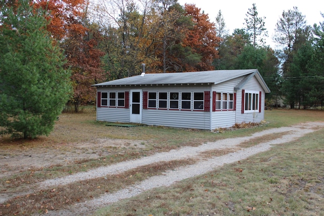 94 E Cherry Creek Rd, Mio, MI 48647 - view of front of house featuring a front lawn