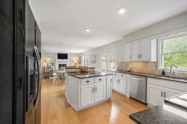 5616 Stoney Brook Rd, Kalamazoo, MI 49009 - kitchen with black refrigerator with ice dispenser, dishwasher, light wood-style floors, a sink, and recessed lighting