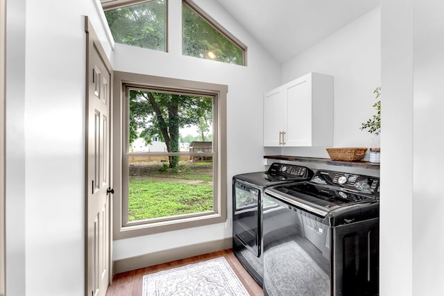 925 133rd Ave, Wayland, MI 49348 - washroom featuring washer and dryer, cabinet space, light wood-style floors, and baseboards