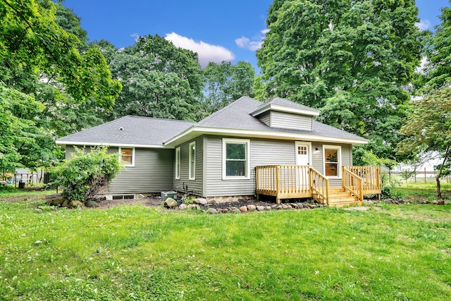 925 133rd Ave, Wayland, MI 49348 - rear view of house featuring a wooden deck, a lawn, roof with shingles, and view of scattered trees