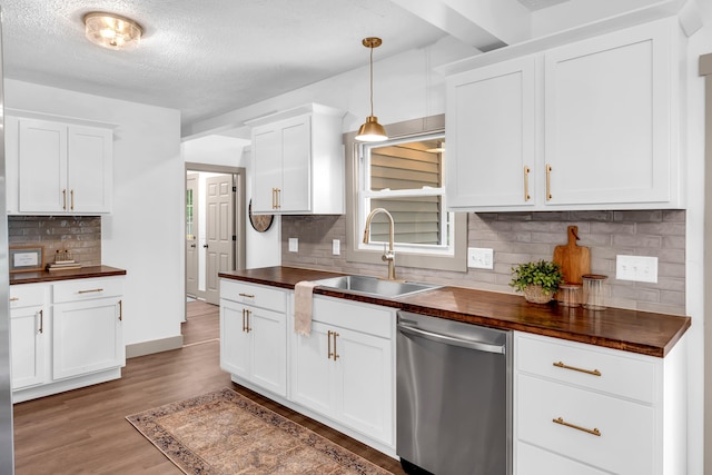 925 133rd Ave, Wayland, MI 49348 - kitchen featuring butcher block countertops, dishwasher, a sink, backsplash, and a textured ceiling