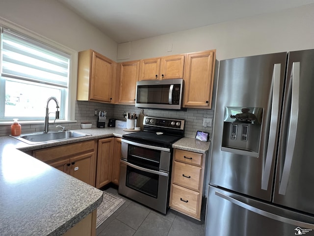 5304 E Dunbar Rd, Monroe, MI 48161 - kitchen featuring stainless steel appliances, a sink, light tile patterned floors, and decorative backsplash