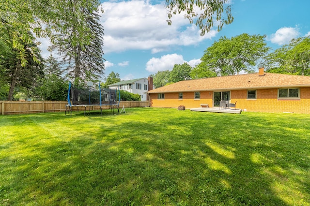 1110 Piccadilly Rd, Kalamazoo, MI 49006 - view of yard with a trampoline and a deck
