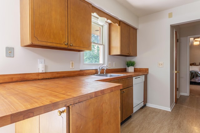 1110 Piccadilly Rd, Kalamazoo, MI 49006 - kitchen with dishwasher, a sink, light wood finished floors, and brown cabinetry