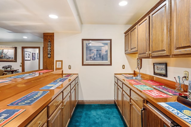6242 131st Ave, Saugatuck, MI 49453 - kitchen with dark carpet, baseboards, recessed lighting, brown cabinets, and a sink