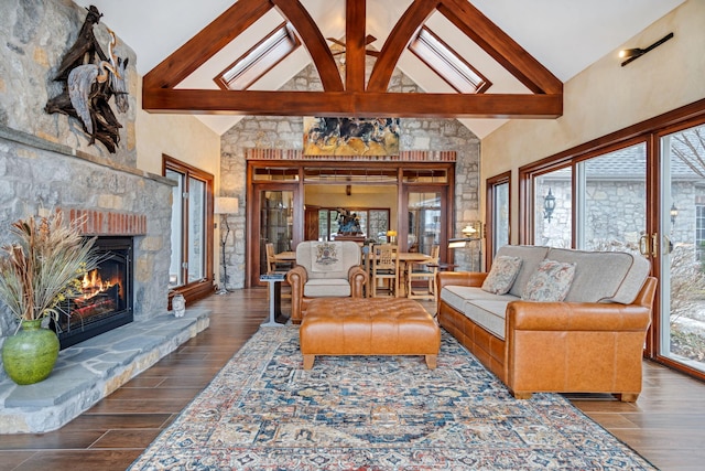 6242 131st Ave, Saugatuck, MI 49453 - living room with high vaulted ceiling, wood finished floors, beam ceiling, and a stone fireplace