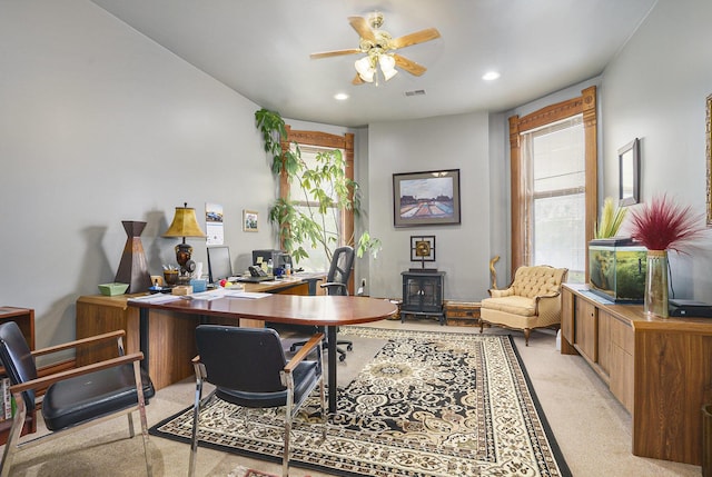 318 Houston Ave, Muskegon, MI 49441 - home office featuring a ceiling fan, light colored carpet, recessed lighting, and a wood stove