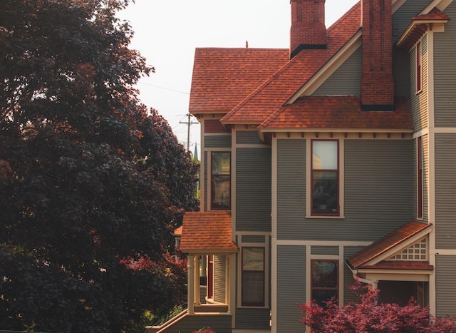 318 Houston Ave, Muskegon, MI 49441 - view of side of home featuring a chimney and a shingled roof